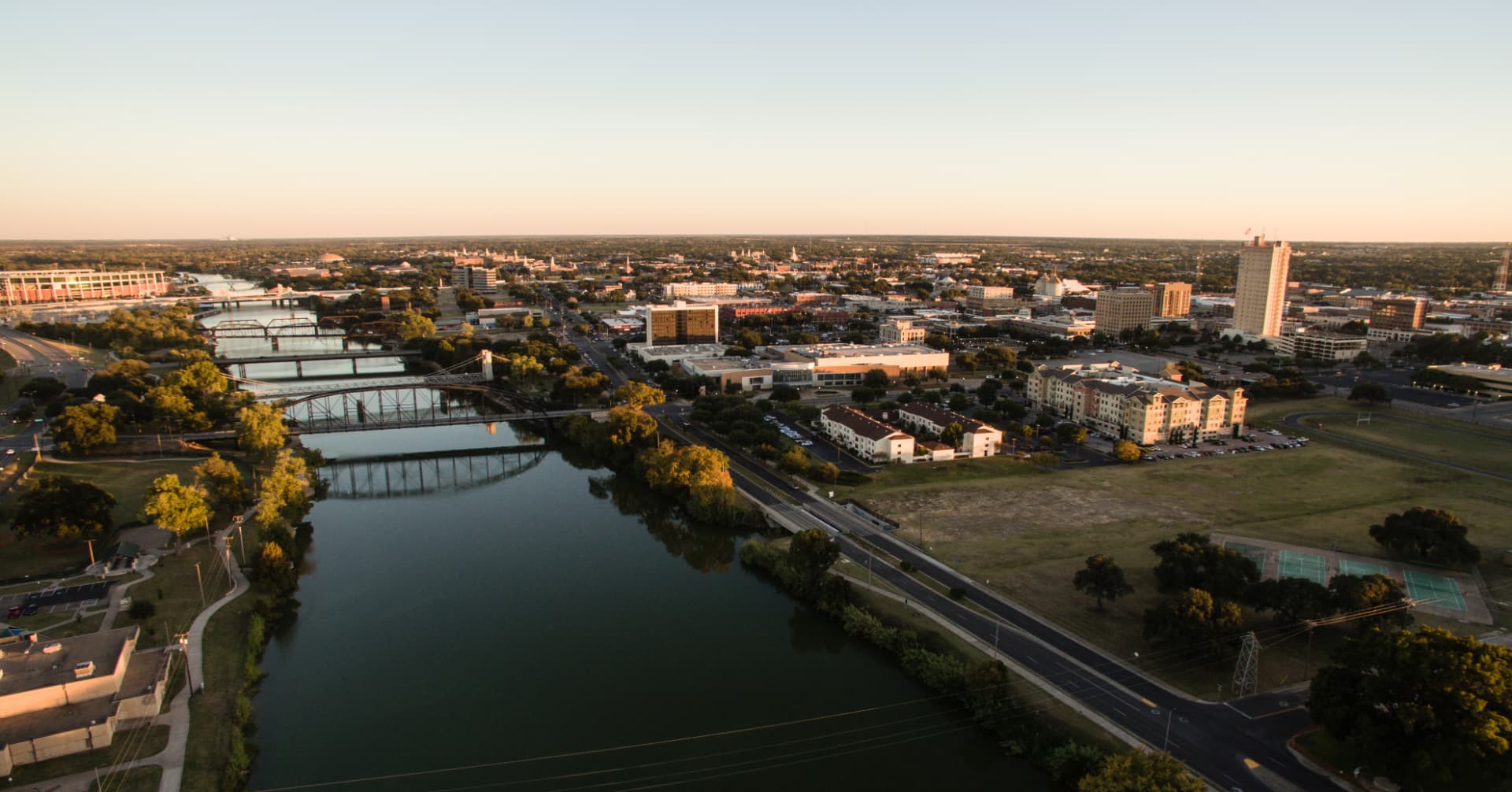Aerial view of the Brazos River and downtown Waco at sunset